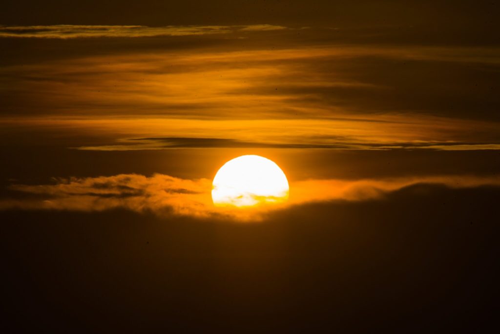 sun setting over the clouds